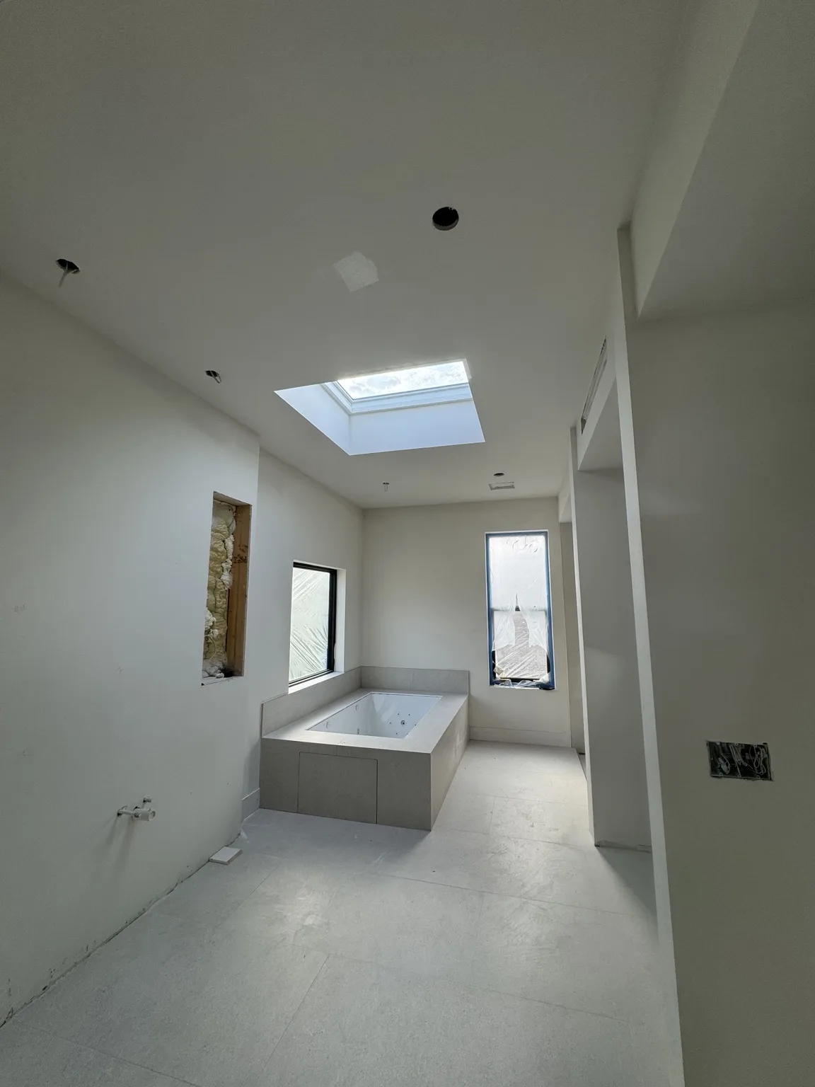 Drywall finish around a skylight and recessed ceiling