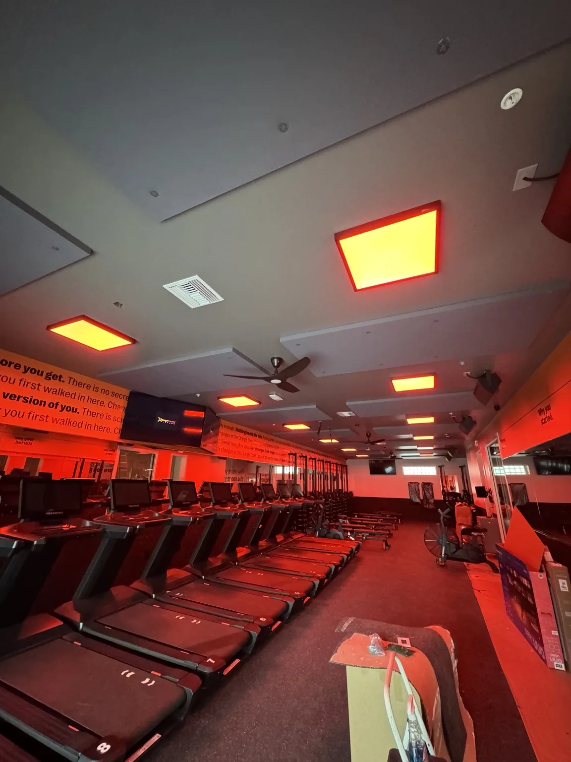 Completed fitness studio interior with illuminated ceiling panels